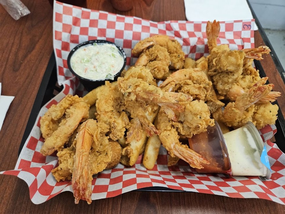 Seafood menu showing shrimp, oysters, and crab claws.