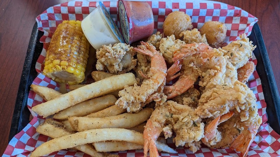 Counter menu featuring fried fish and shrimp burgers.