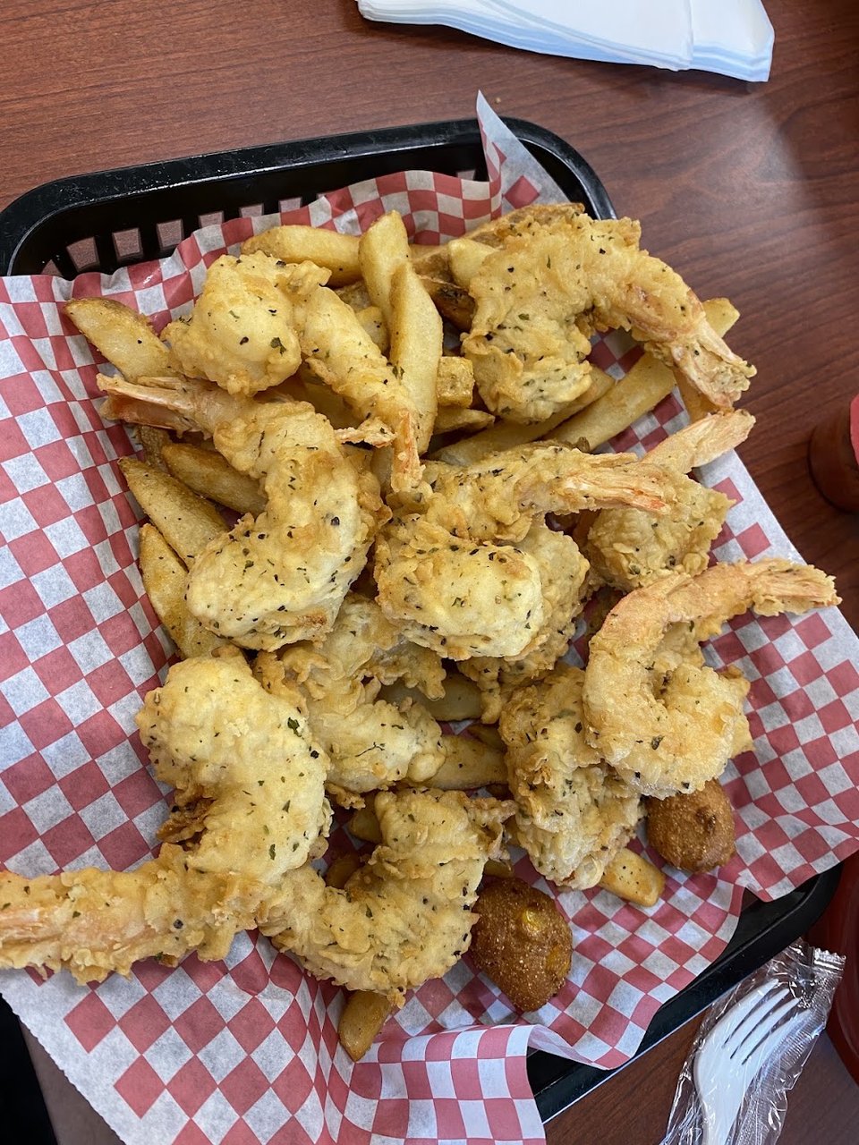 Menu board with fried seafood platters and burgers.