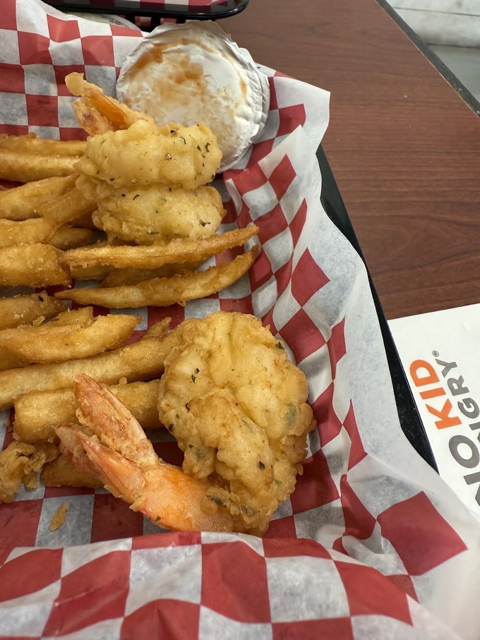 Counter menu featuring fried fish and shrimp burgers.