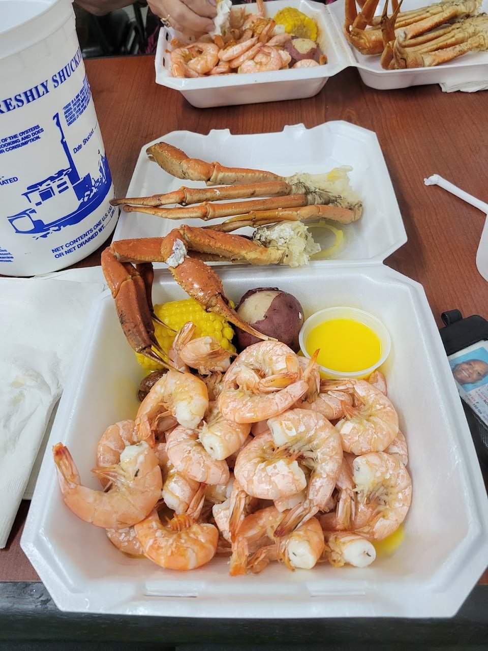 Seafood menu showing shrimp, oysters, and crab claws.