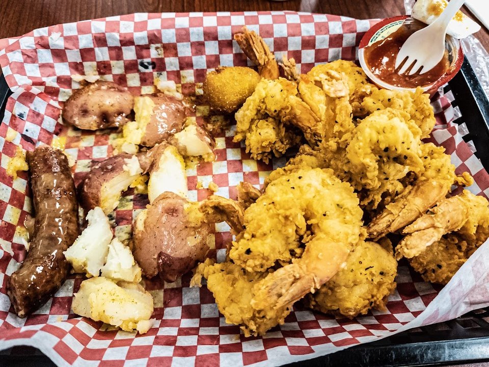 Counter menu featuring fried fish and shrimp burgers.