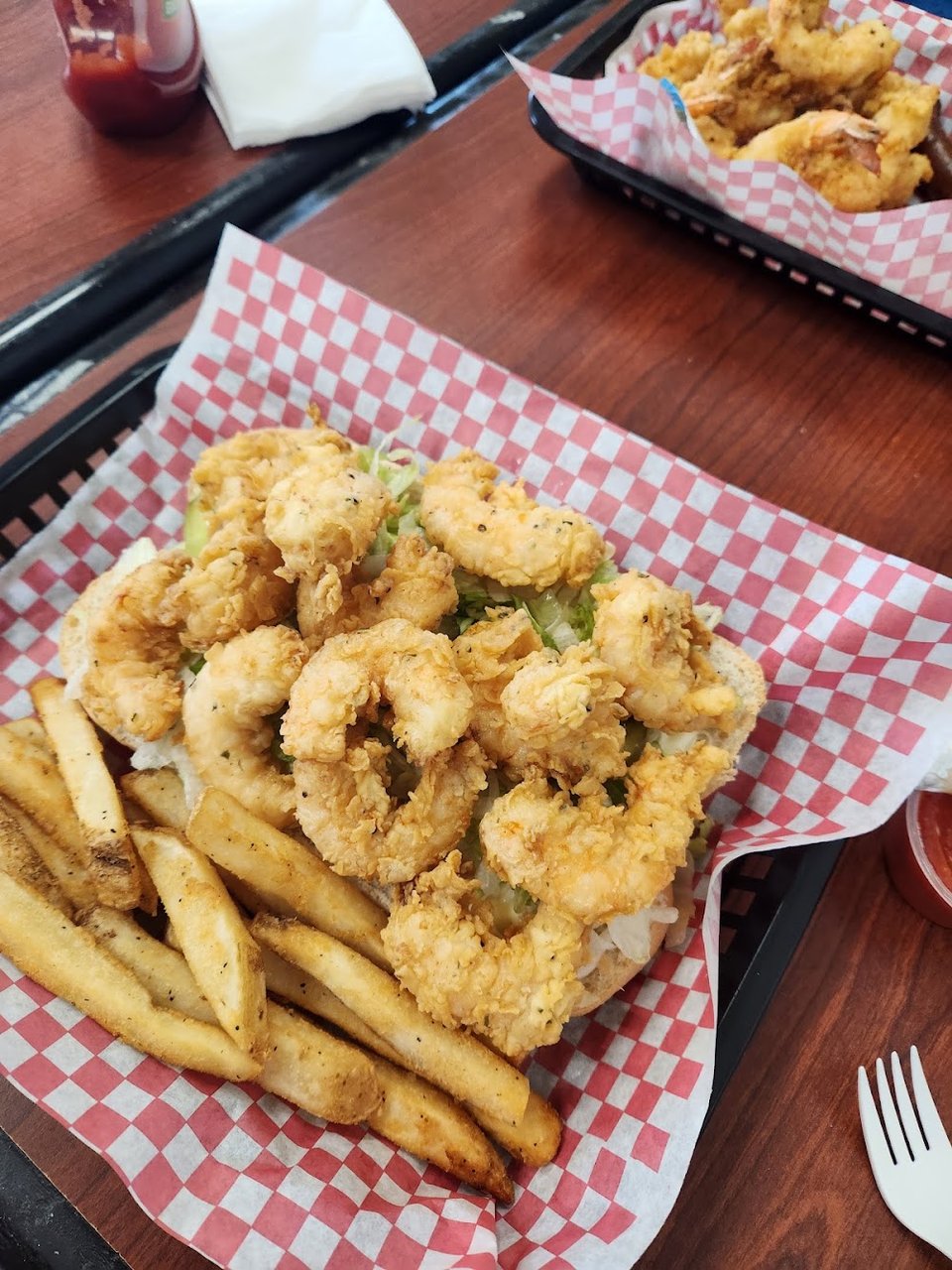 Menu board with fried seafood platters and burgers.